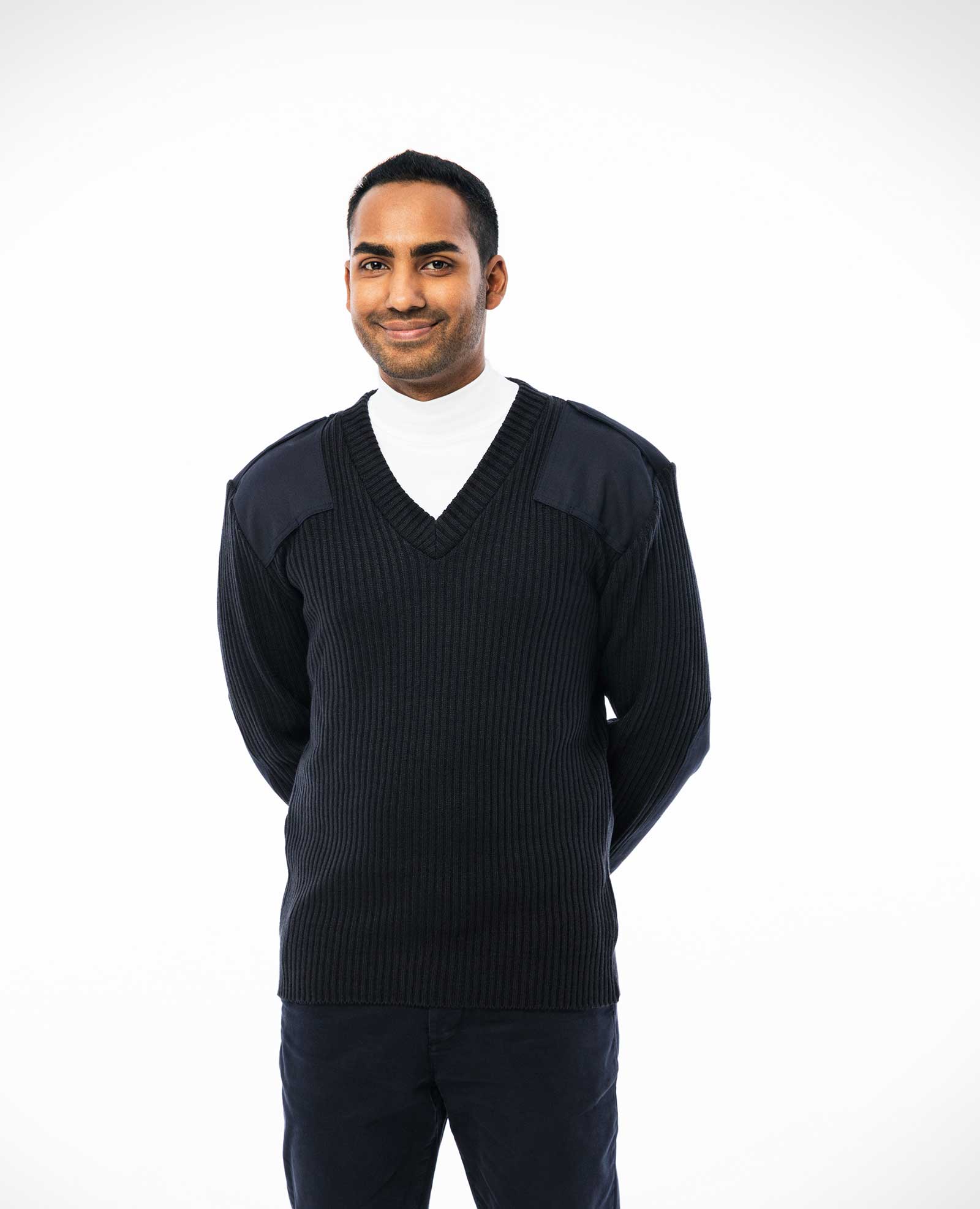man wearing navy v-neck sweater with shoulder and elbow patches